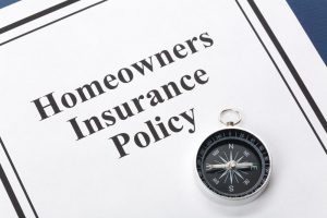 homeowners policy next to a compass